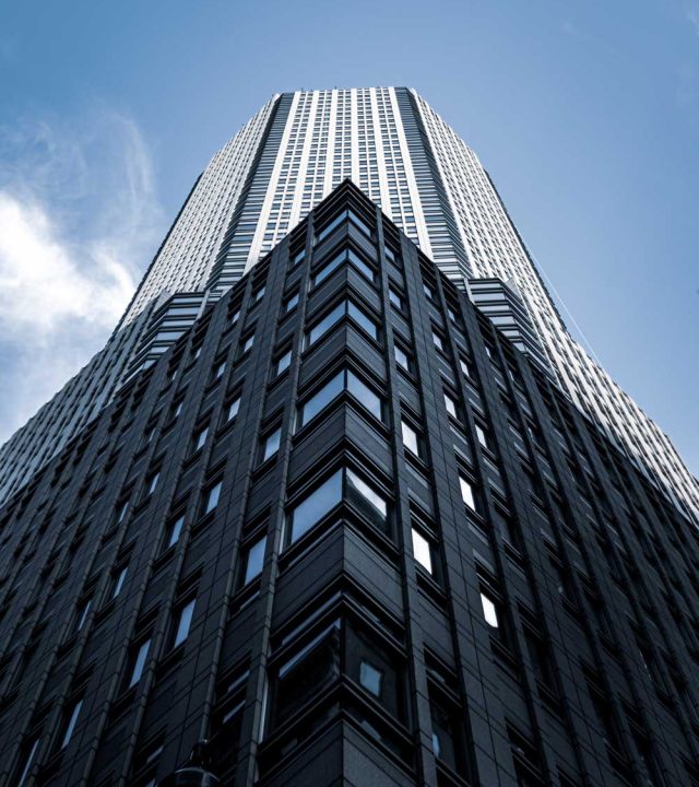low-angle-shot-tall-city-building-with-blue-sky-background-new-york